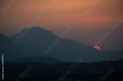 Sunset view behind the mountains background picture