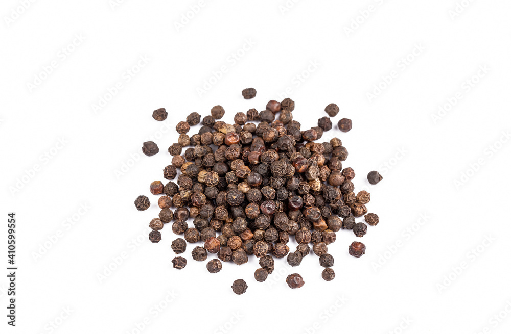 Dried black pepper on the white background Dried black pepper on the white background