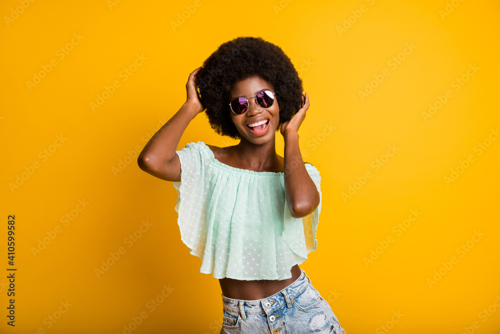 Photo portrait of woman touching hair isolated on vivid yellow colored background - obrazy, fototapety, plakaty 