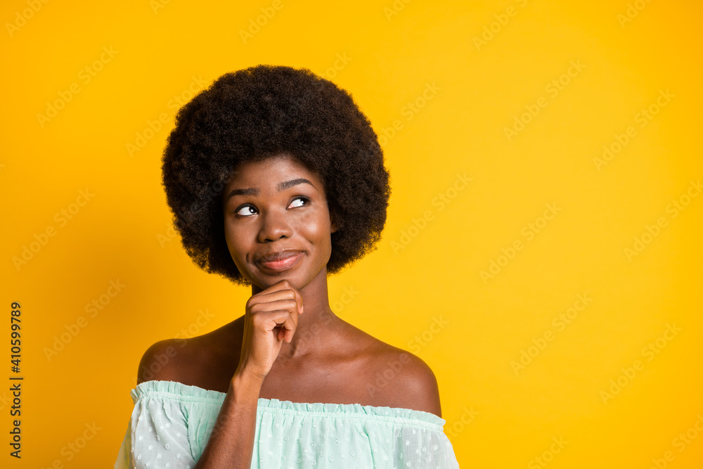 Photo portrait of dreamy woman looking at blank space touching chin face with finger isolated on vivid yellow colored background Photo portrait of dreamy woman looking at blank space touching chin face with finger isolated on vivid yellow colored background
