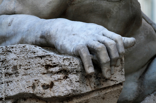 Arm and hand detail of the statue of the 4 rivers in Piazza Navona in Rome