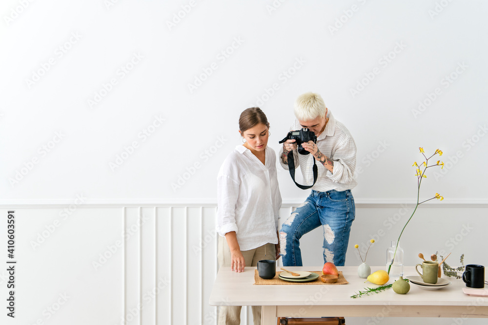Blogger photographing the plate decor on the dining table Blogger photographing the plate decor on the dining table