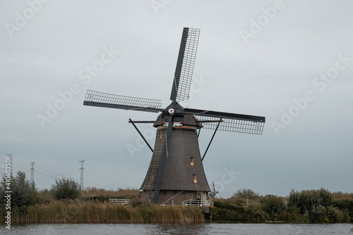 Dutch traditional landscape with old windmills in kinderdijk, Rotterdam, channel and water ways, green grass