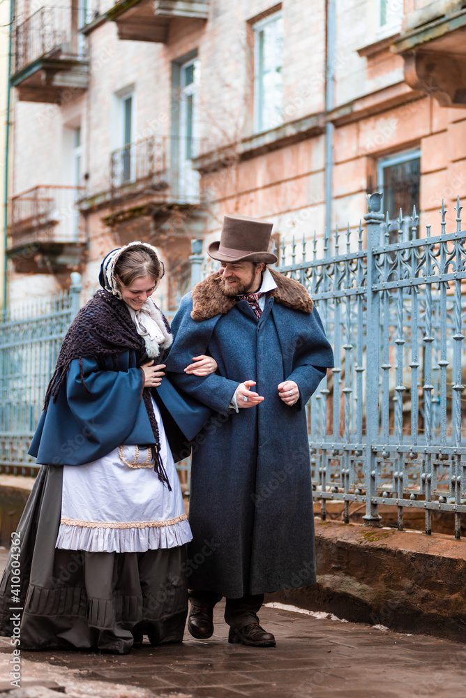 Fototapeta premium The woman and the man in vintage suits. People in retro dresses. Walking by the street.
