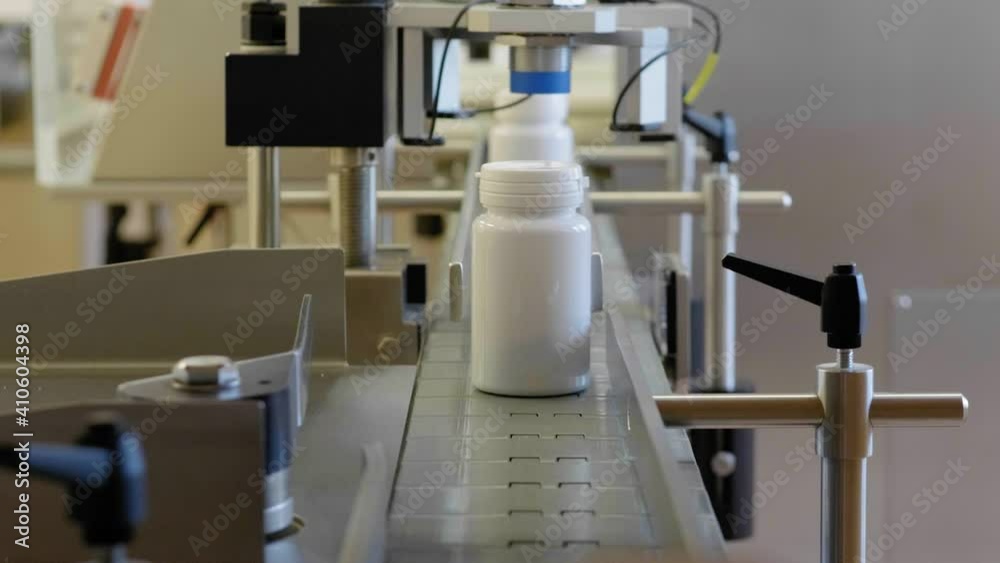 Medical Production for Drugs Supply of Pharmacy Industry Closeup. Manufacturing Plastic Bottle Row on Conveyor Line of Pharmaceutical Factory Medical Production for Drugs Supply of Pharmacy Industry Closeup. Manufacturing Plastic Bottle Row on Conveyor Line of Pharmaceutical Factory