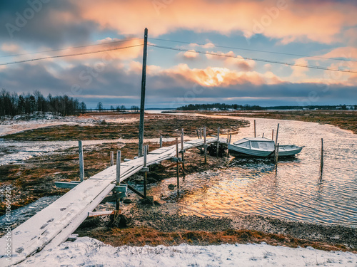 Low tide. Fishing pier in the authentic Northern village of Umba. Kola Peninsula, Russia. photo