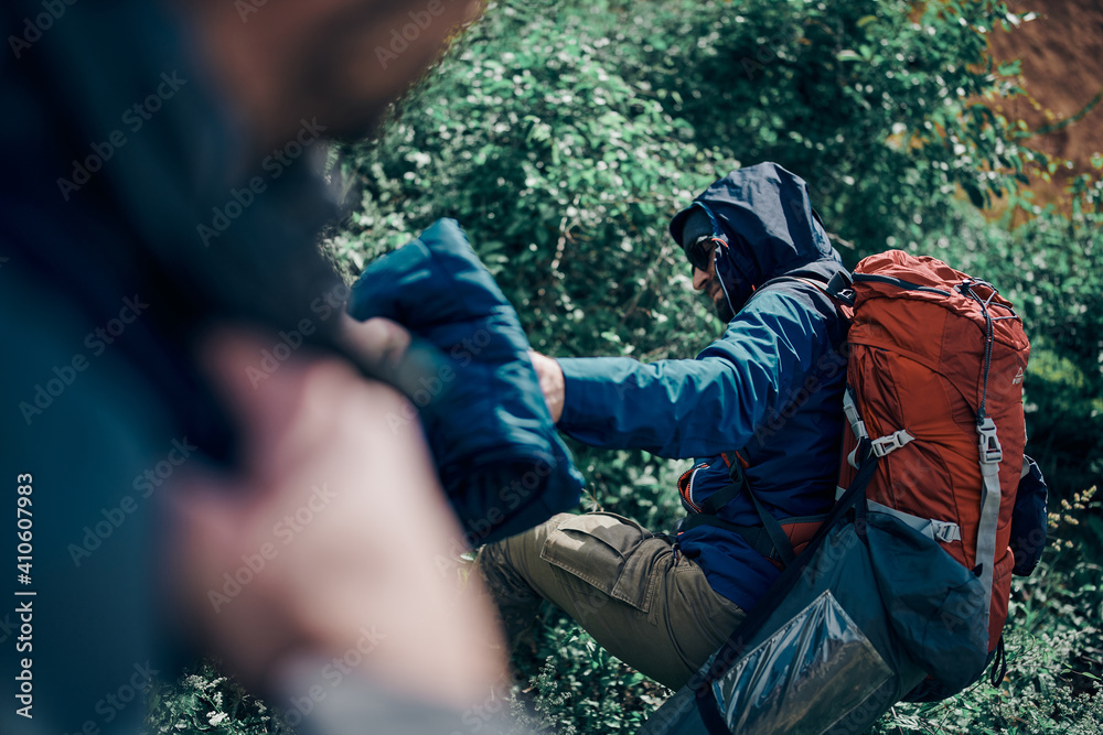 Two hikers climbing the hill. They having backpacks on backs. Two hikers climbing the hill. They having backpacks on backs.