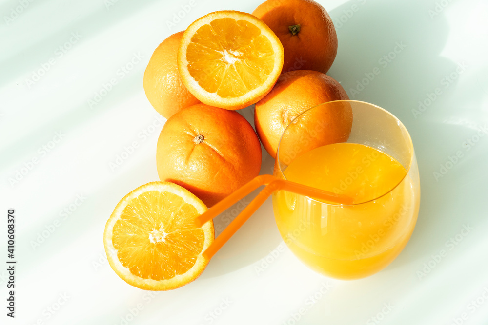 Orange juice in a glass with some oranges around Orange juice in a glass with some oranges around