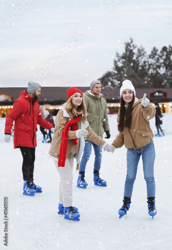 Group of friends skating at outdoor ice rink