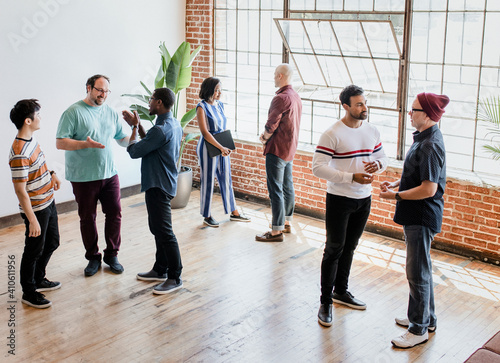 Diverse people talking in groups during a break photo