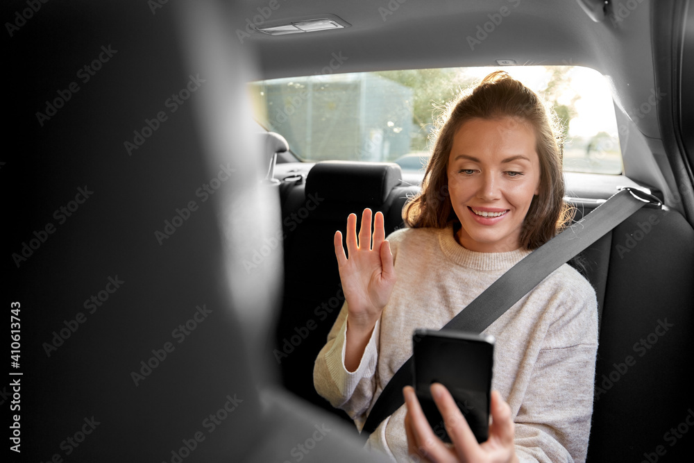 transport, vehicle and technology concept - happy smiling woman or female passenger in taxi car having video call on smartphone