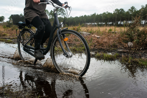 woman cycling on flooded cycle paths photo