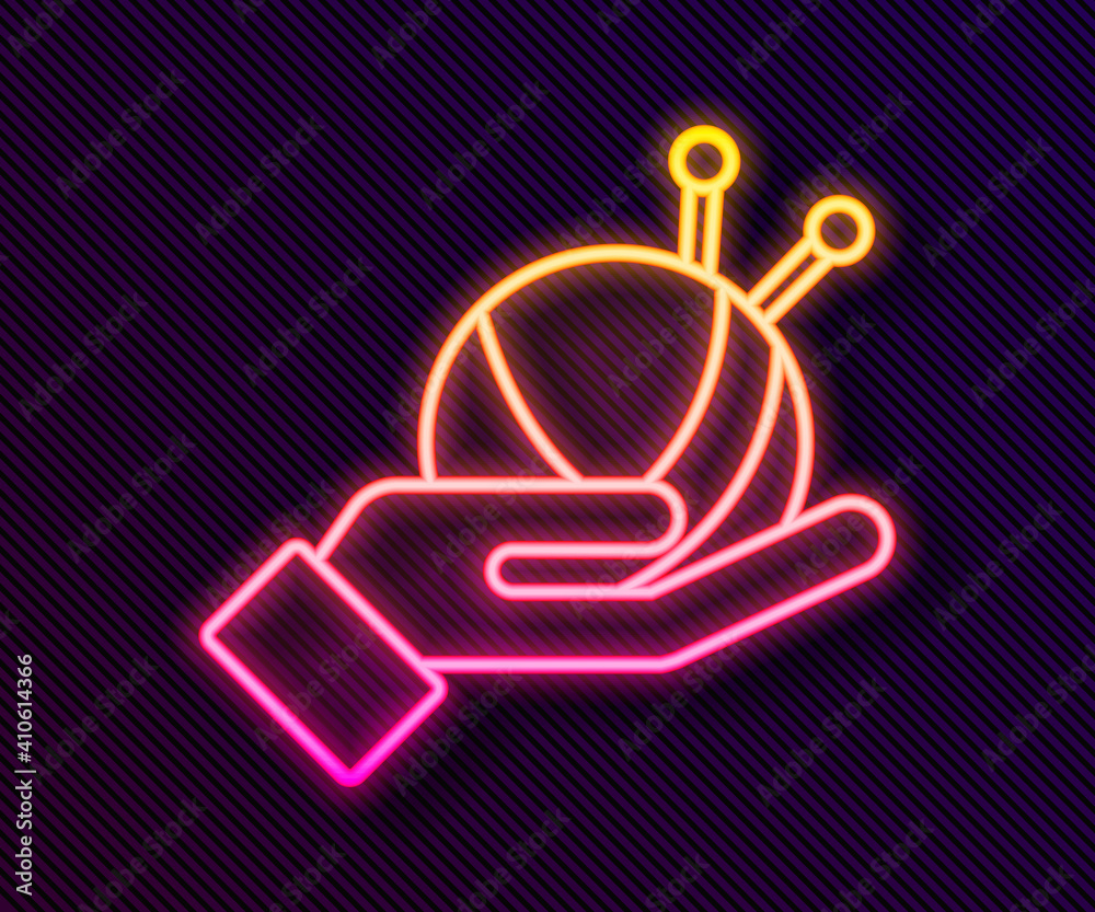 Glowing neon line Yarn ball with knitting needles icon isolated on black background. Label for hand made, knitting or tailor shop. Vector.