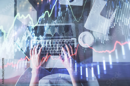 Double exposure of woman hands working on computer and forex chart hologram drawing. Top View. Financial analysis concept.