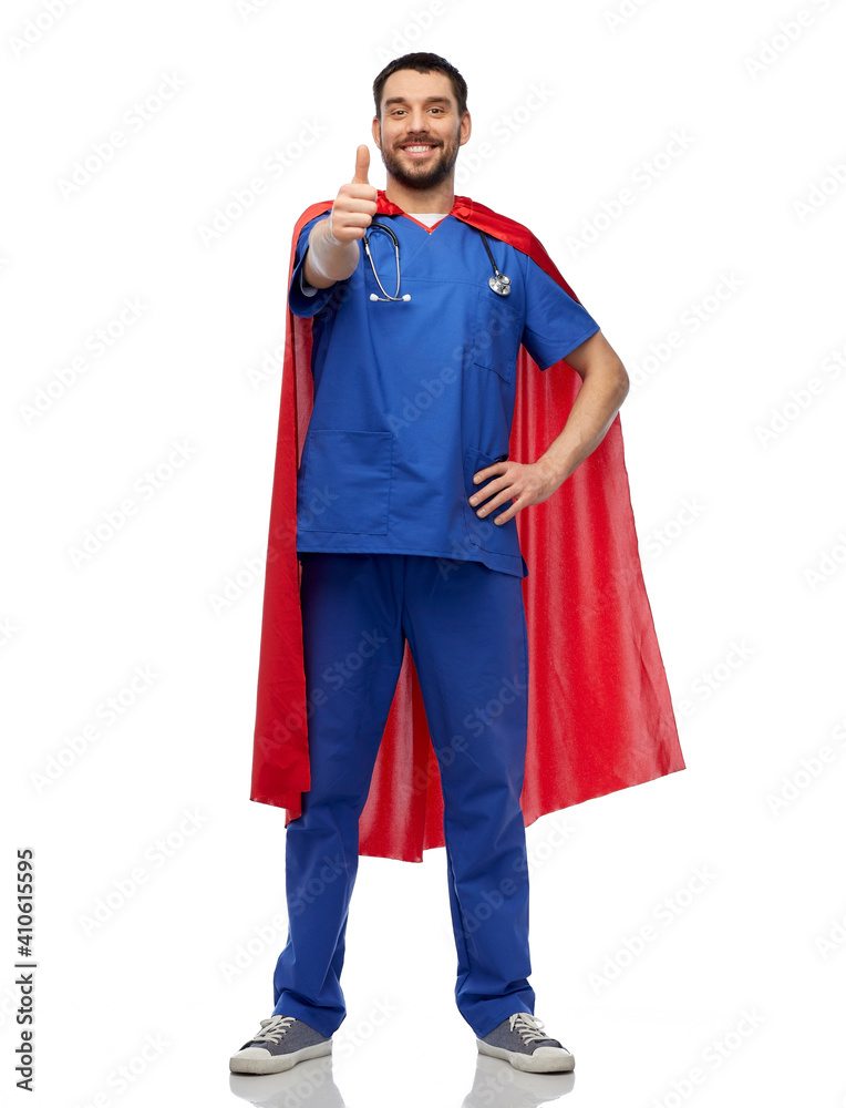 healthcare, profession and medicine concept - happy smiling doctor or male nurse in blue uniform and red superhero cape with stethoscope showing thumbs up over white background healthcare, profession and medicine concept - happy smiling doctor or male nurse in blue uniform and red superhero cape with stethoscope showing thumbs up over white background