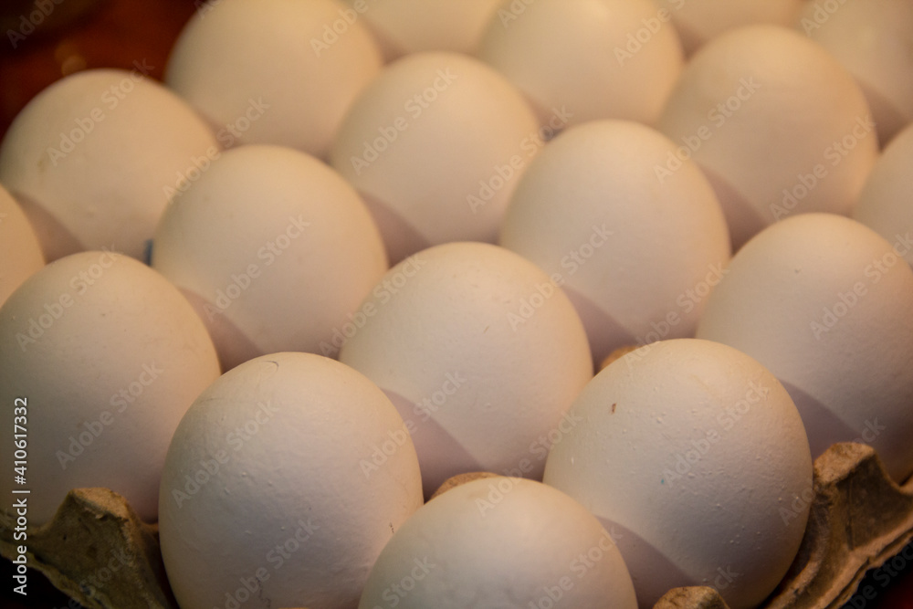 Full package of chicken eggs. Large white chicken eggs in cardboard packaging