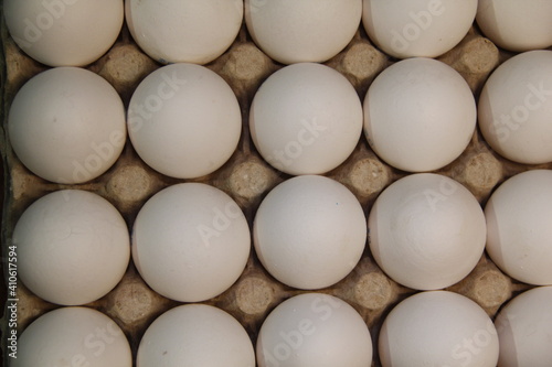 Full package of chicken eggs. Large white chicken eggs in cardboard packaging
