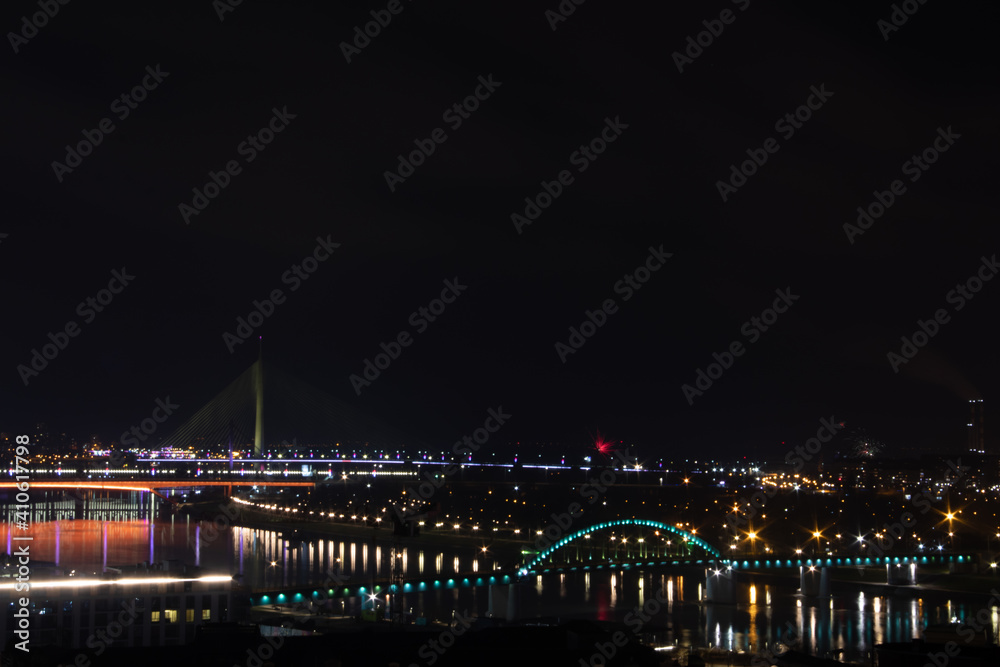 Panoramic view on Belgrade by night, vie on Sava River and bridges over it, and waterfront brand new buildings