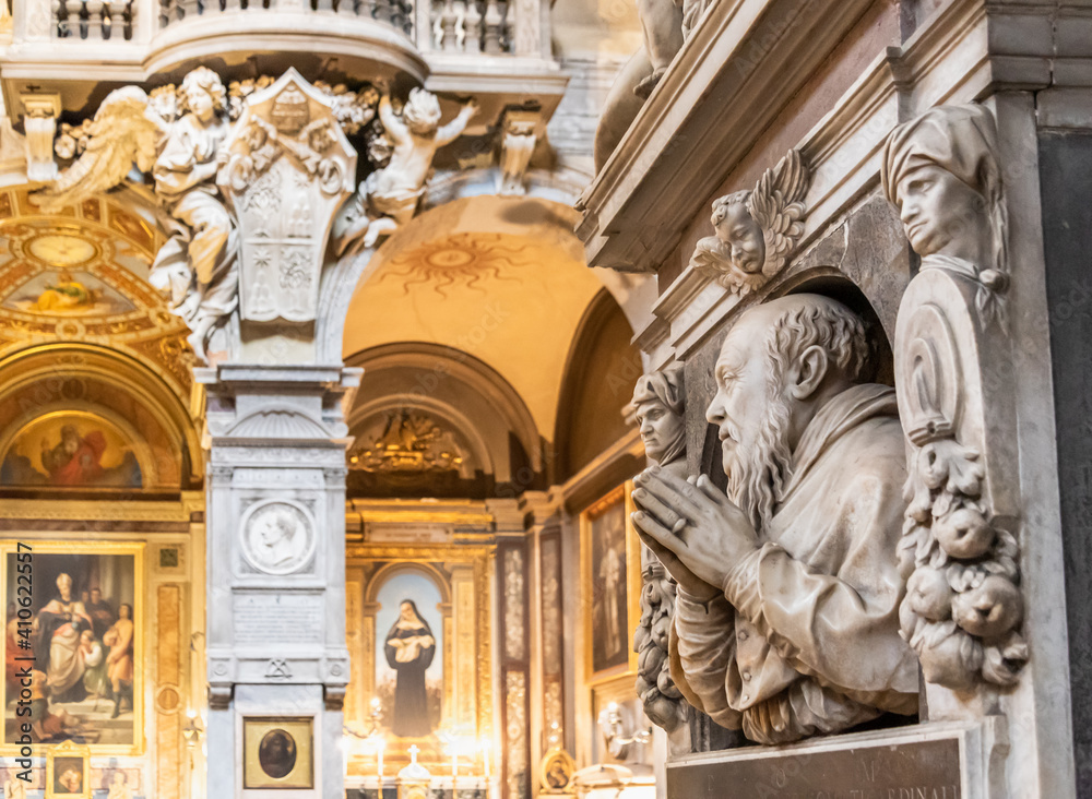 View of interior decoration of catholic church in Rome, with marble statues of saints carved on marble walls