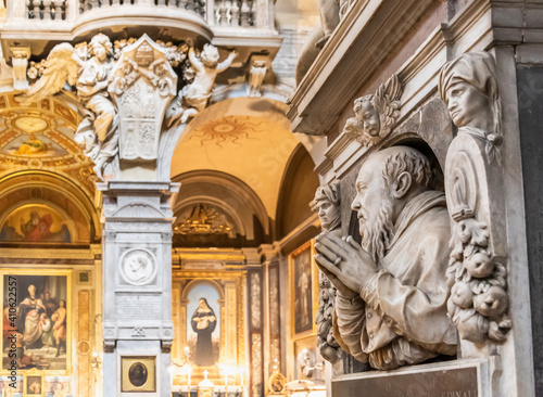 View of interior decoration of catholic church in Rome  with marble statues of saints carved on marble walls