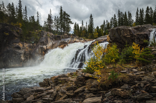 Hyttfossen waterfall in autumnal scenery