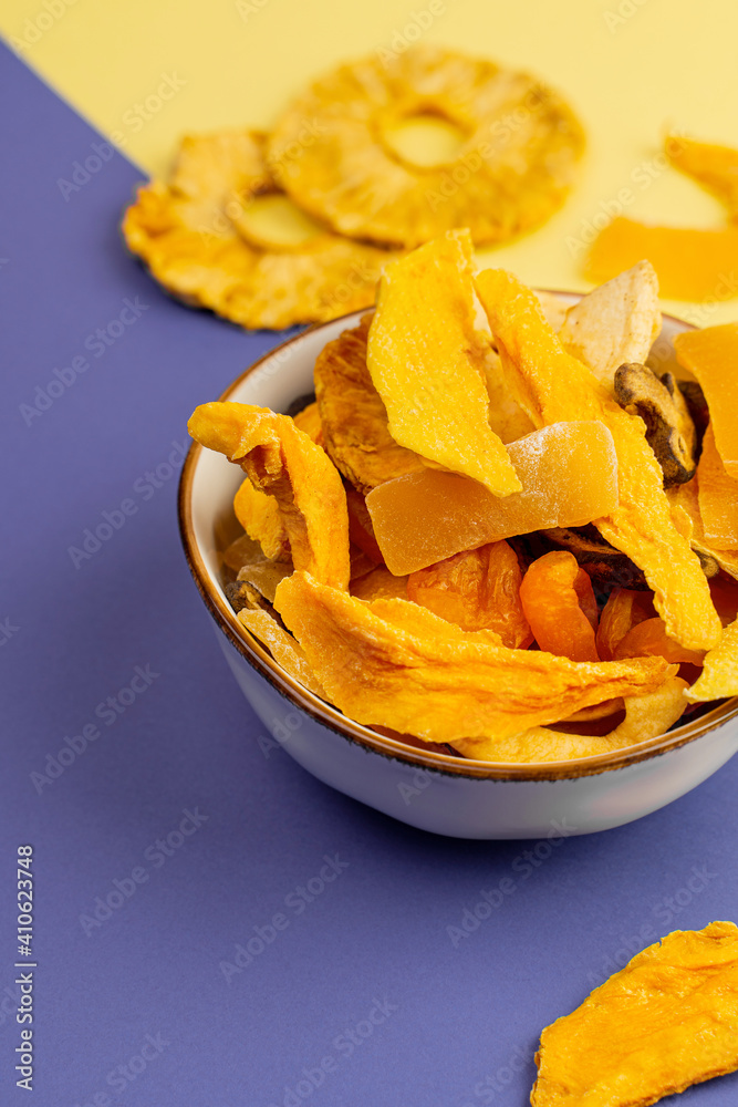 Ceramic bowl with assorted vegan jerky on yellow and purple background, top view Ceramic bowl with assorted vegan jerky on yellow and purple background, top view