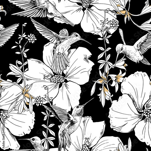 Seamless floral pattern. Exotic Tropical Hibiscus flowers and hummingbirds on a black background. Textile composition, hand drawn style print. Vector illustration.