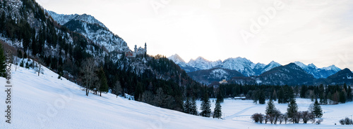 Panoramic mountain view: Castle Neuschwanstein (Hohenschwangau, Germany) during winter photo