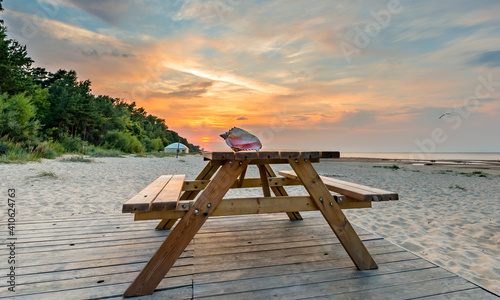 Colorful sunrise on sandy beach of Jurmala - famous Baltic tourist  resort in...