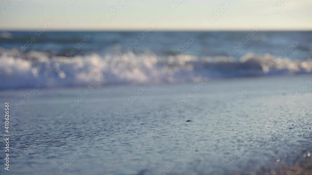 Low angle view of wet sand at the beach with blurred background Low angle view of wet sand at the beach with blurred background