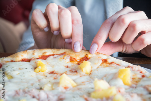 Female hand take slice of pizza