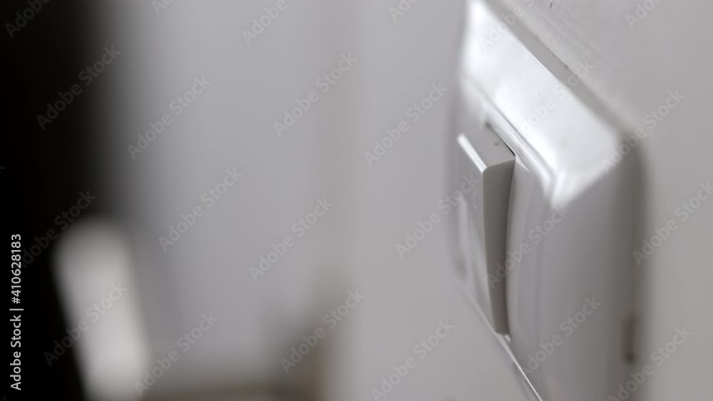 Earth Hour, Close up male hand turn off the light to saving electrical ...