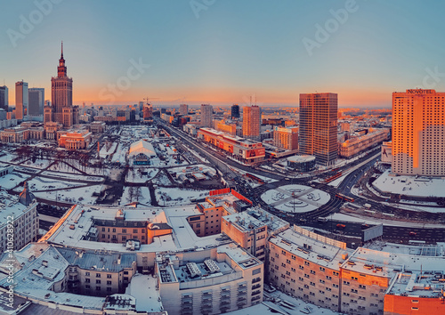 Beautiful panoramic aerial drone view on Warsaw City Skyscrapers, PKiN, and Varso Tower under construction and 19th-century tenement houses during the January sunset, Warsaw, Poland.