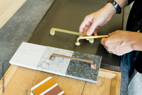 Designer woman choosing details of new kitchen in a home improvement store. Real estate, home renovation, small business concept