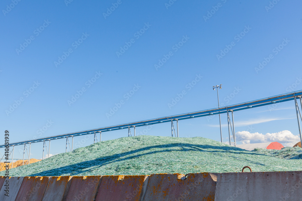 Fragments of blue glass. Small and sharp fragments of broken glass. cullet for creation of new glass are ready to be remelted. Fragments of blue glass. Small and sharp fragments of broken glass. cullet for creation of new glass are ready to be remelted.