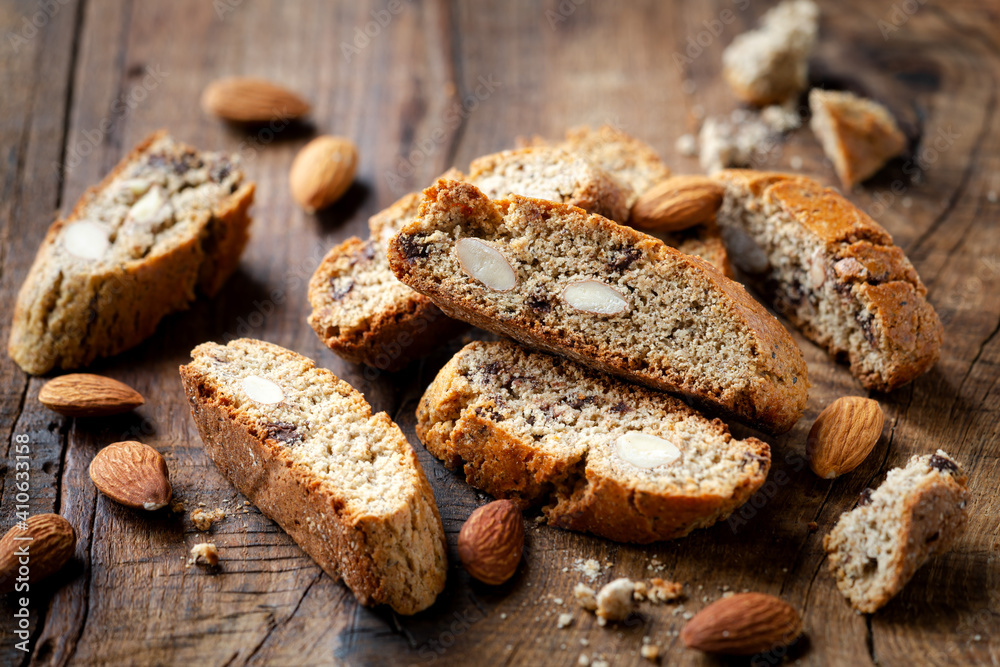 Homemade gluten free biscotti or cantuccini made of buckwheat flour with almonds and chocolate chips on dark rustic wooden background Homemade gluten free biscotti or cantuccini made of buckwheat flour with almonds and chocolate chips on dark rustic wooden background