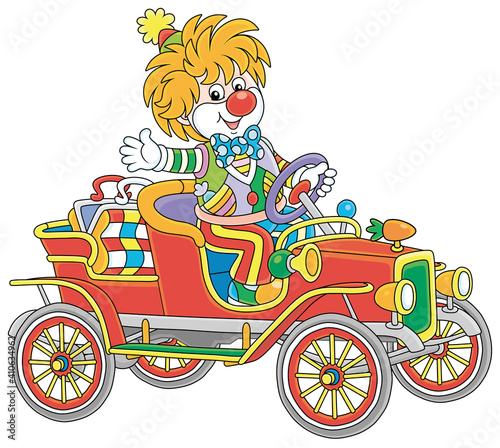 Friendly smiling clown in a colorful comic suit driving a funny retro car in a circus performance, vector cartoon illustration isolated on a white background