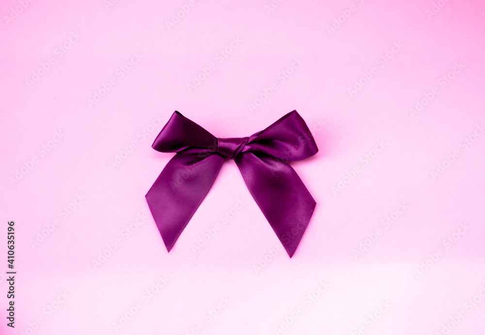 burgundy bow on a pink background. kind of sverhu