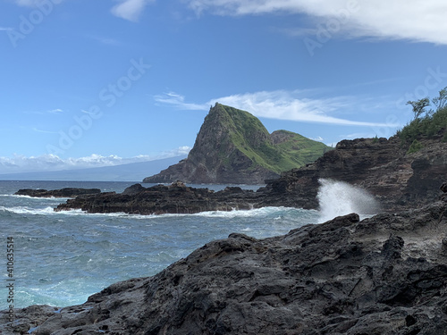 Fototapeta Coastline view of the volcanic rocks in the ocean splashing at the cove on the I