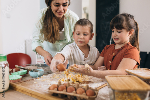 mother and children baking together at home
