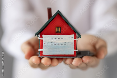 House with medical mask in children`s hands