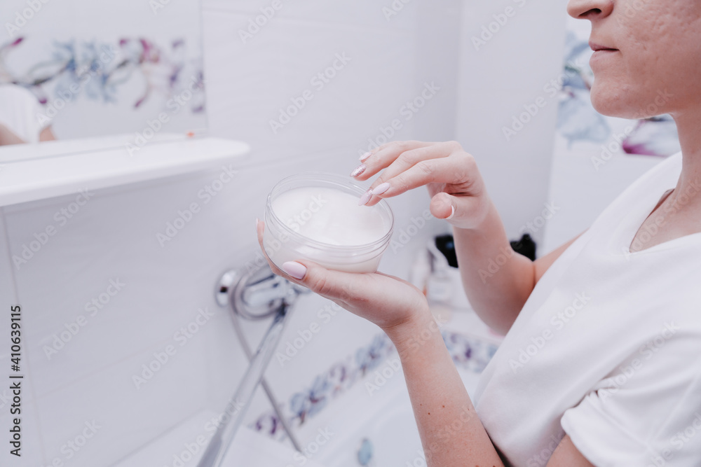 Girl using moisturizer. Cream hand apply face cosmetic concept Girl using moisturizer. Cream hand apply face cosmetic concept