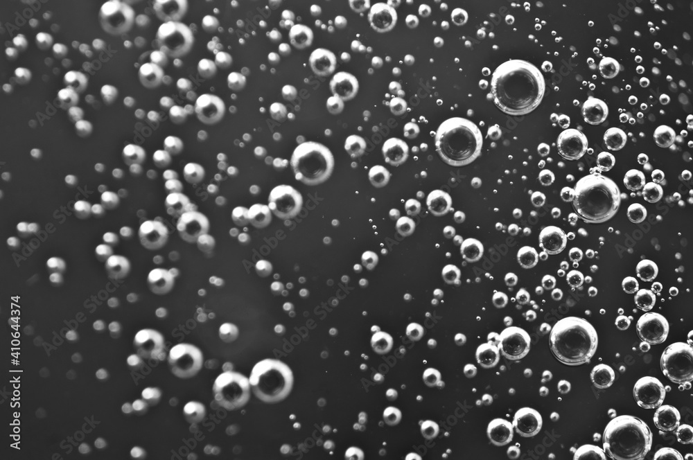 Black and white. Bubbles from soda water or champagne, beer or other liquid with air, oxygen or carbon dioxide bubbles.