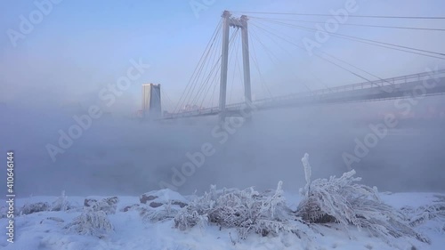 Wallpaper Mural The town bridge over the river in the winter time. Urban landscape with a bridge over the river and a very cold season Torontodigital.ca