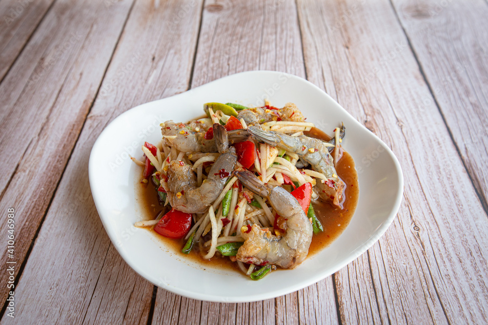 Papaya salad with shrimp in white on black background. Thai food delicious and popular Papaya salad with shrimp in white on black background. Thai food delicious and popular