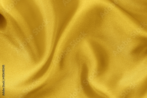 Golden yellow fabric cloth texture for background and design art work, beautiful crumpled pattern of silk or linen.