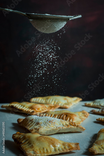 sugar falling on nutella hand pies.