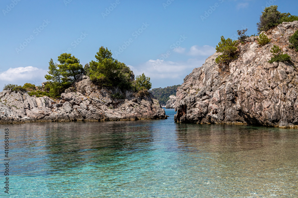 Big Rock in the blue waters of Stafilos Beach, Skopelos, Skopelos Island, Greece.