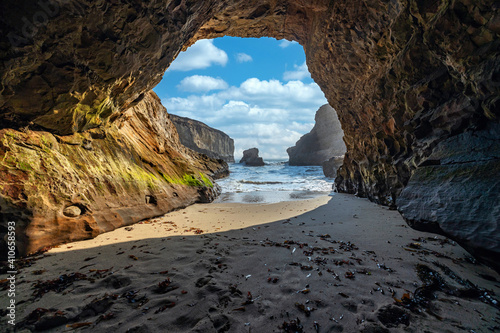 A small cave in the bay of shark fin, beautiful beach landscape on the coast of the California Highway, ocean, rocks, great sky, clear sunny weather.