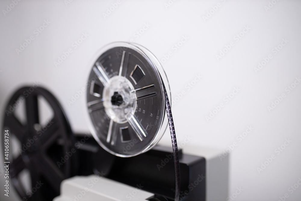 Isolated 8mm projector. Antique video technology. Old retro machine for films. Space for text. Grey background